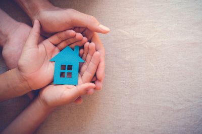 Hands holding a blue paper house, is it time to remortgage?