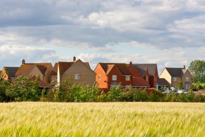 Residential houses with the countryside in the foreground.