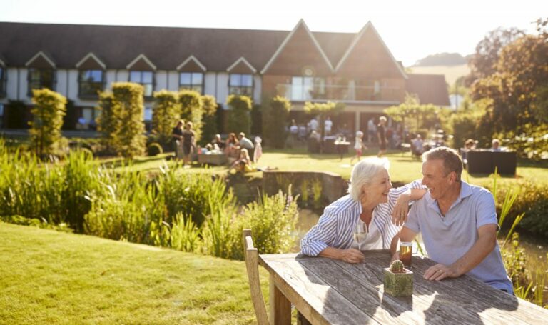 Couple having a drink outside a pub, celebrating a windfall