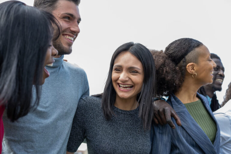 Beautiful smiling people, young group of friends having fun outdoor, focus on the Indian girl smiling
