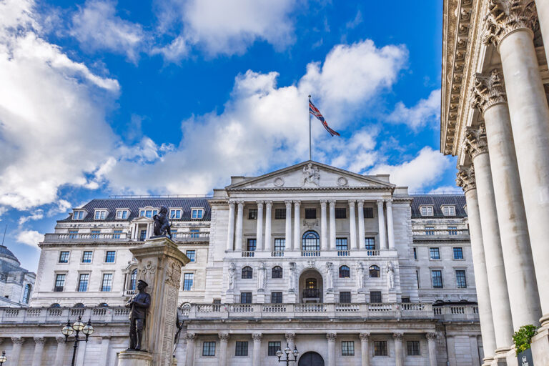 Stunning view of the Bank of England grand neoclassical facade with columns under a vibrant blue sky. London, UK, 29 March 2024